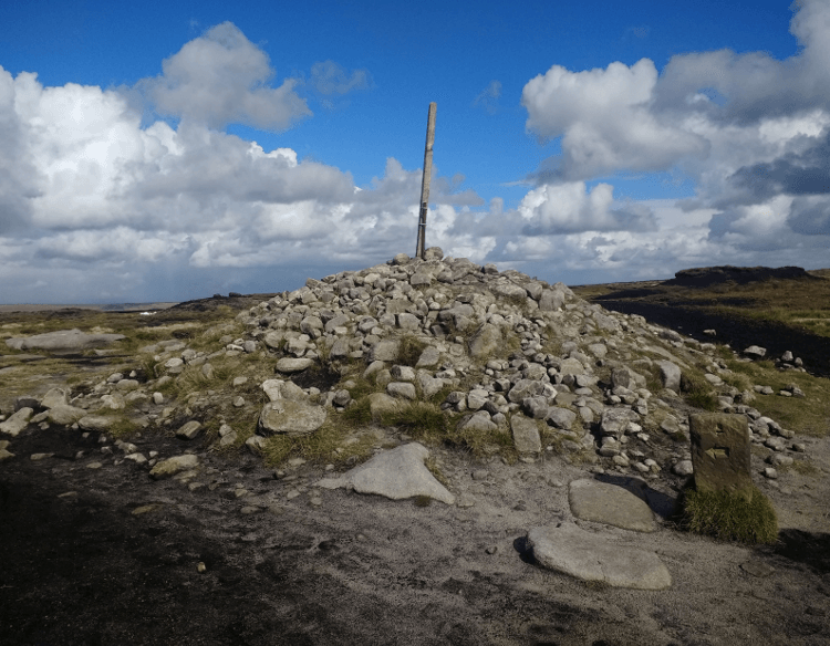 An enormous cairn of stacked stones at Bleaklow Head.